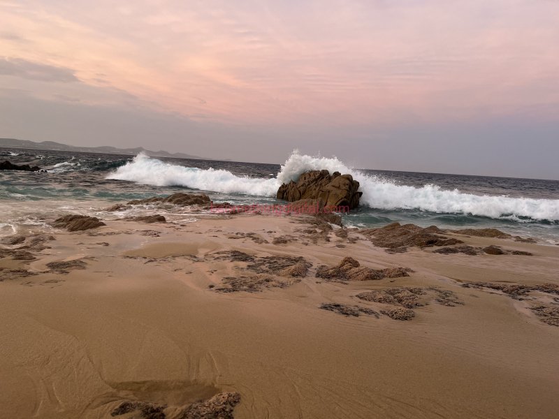 Waves crash on stone