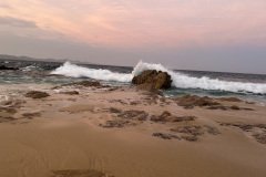 Waves crash on stone